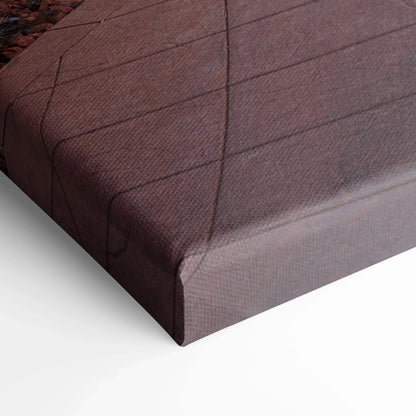 Close-up of textured canvas wrap corner in dark muted colors for wall art display.