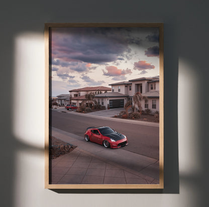 Red Nissan 370z parked in suburban neighborhood at sunset, framed poster wall art.