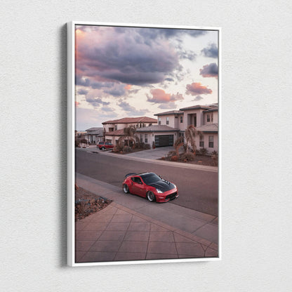 Red Nissan 370z parked on suburban street under colorful sunset sky vertical canvas wall art.