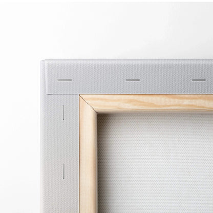 Close-up of wooden frame and white canvas texture on vertical canvas wall art.