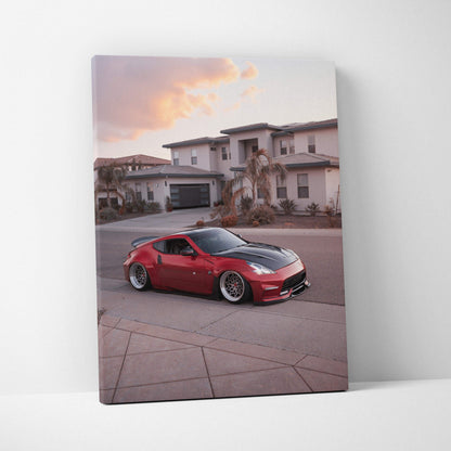 Red Nissan 370z sports car against suburban sunset backdrop on vertical canvas wall art.