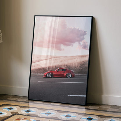 Nissan 370z poster with red sports car against a sunset sky, high-resolution wall art in black frame.