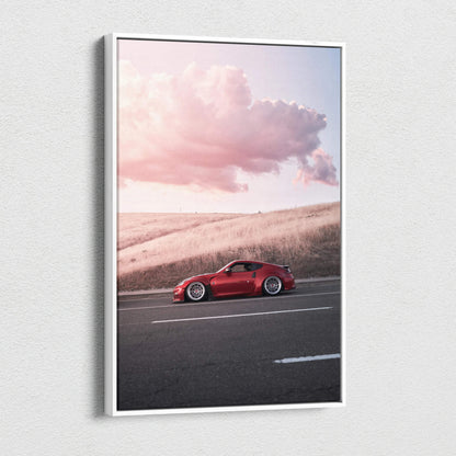 Vertical canvas wall art featuring a red Nissan 370z against a soft sunset sky with clouds.