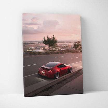 Red Nissan 370z on roadside at sunset canvas wall art print with soft pink sky background.