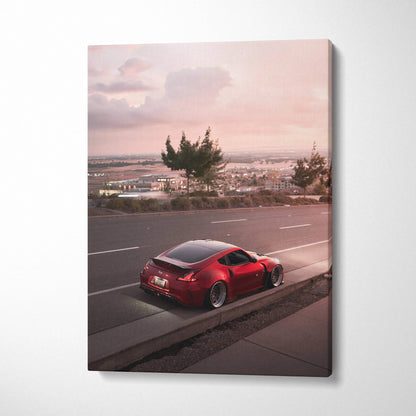 Red Nissan 370z parked by roadside at sunset on vertical canvas wall art.