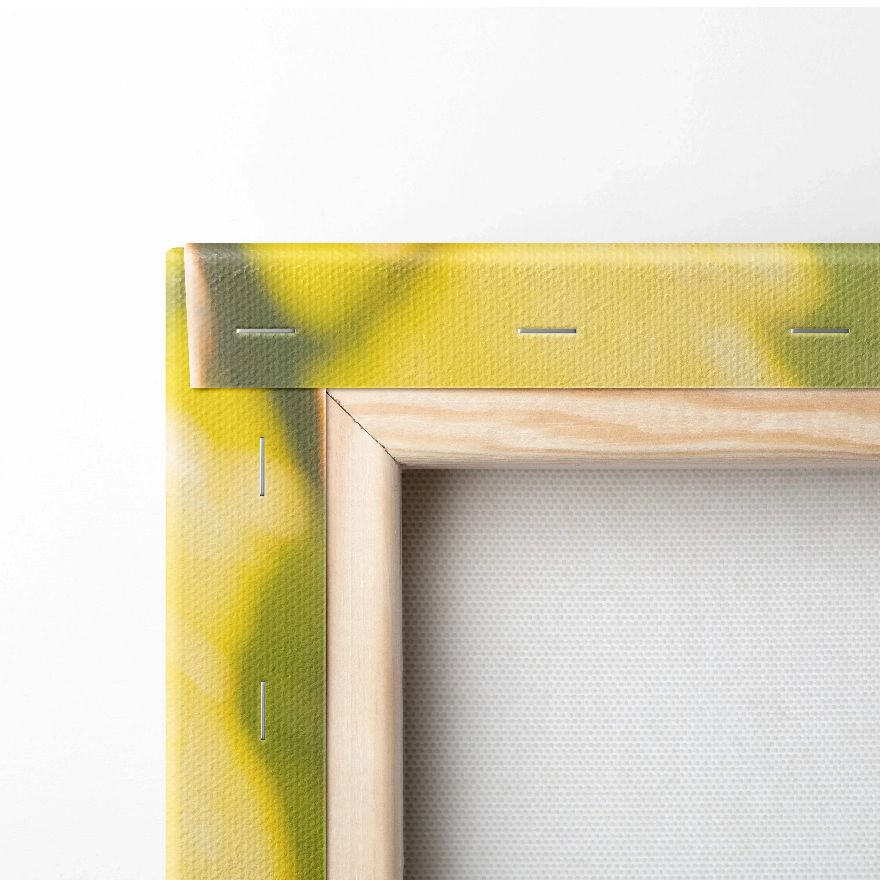 Close-up of wooden frame corner with yellow and green abstract painted canvas stretched and stapled for wall art decor.