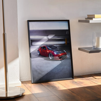 Nissan 370Z red sports car poster in black frame leaning against wall on wooden floor, stylish wall art.