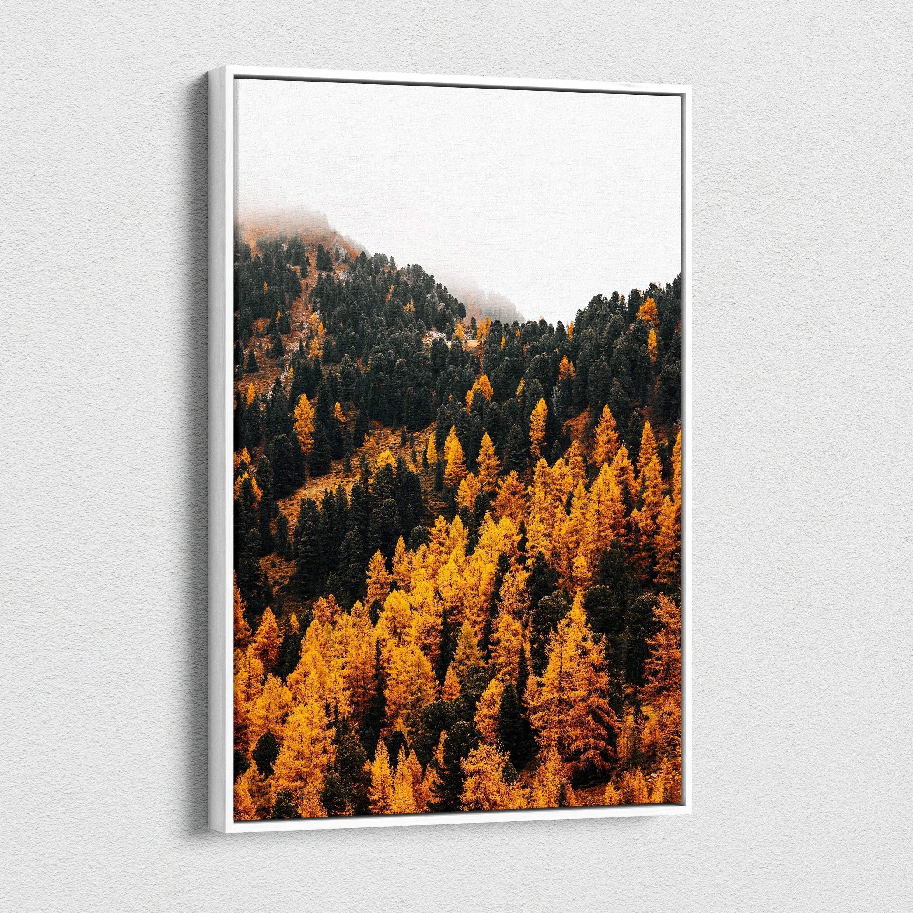 Vertical canvas wall art featuring vibrant autumn mountain forest with golden and dark green trees under a misty sky.