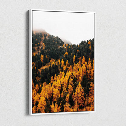 Vertical canvas wall art featuring vibrant autumn mountain forest with golden and dark green trees under a misty sky.