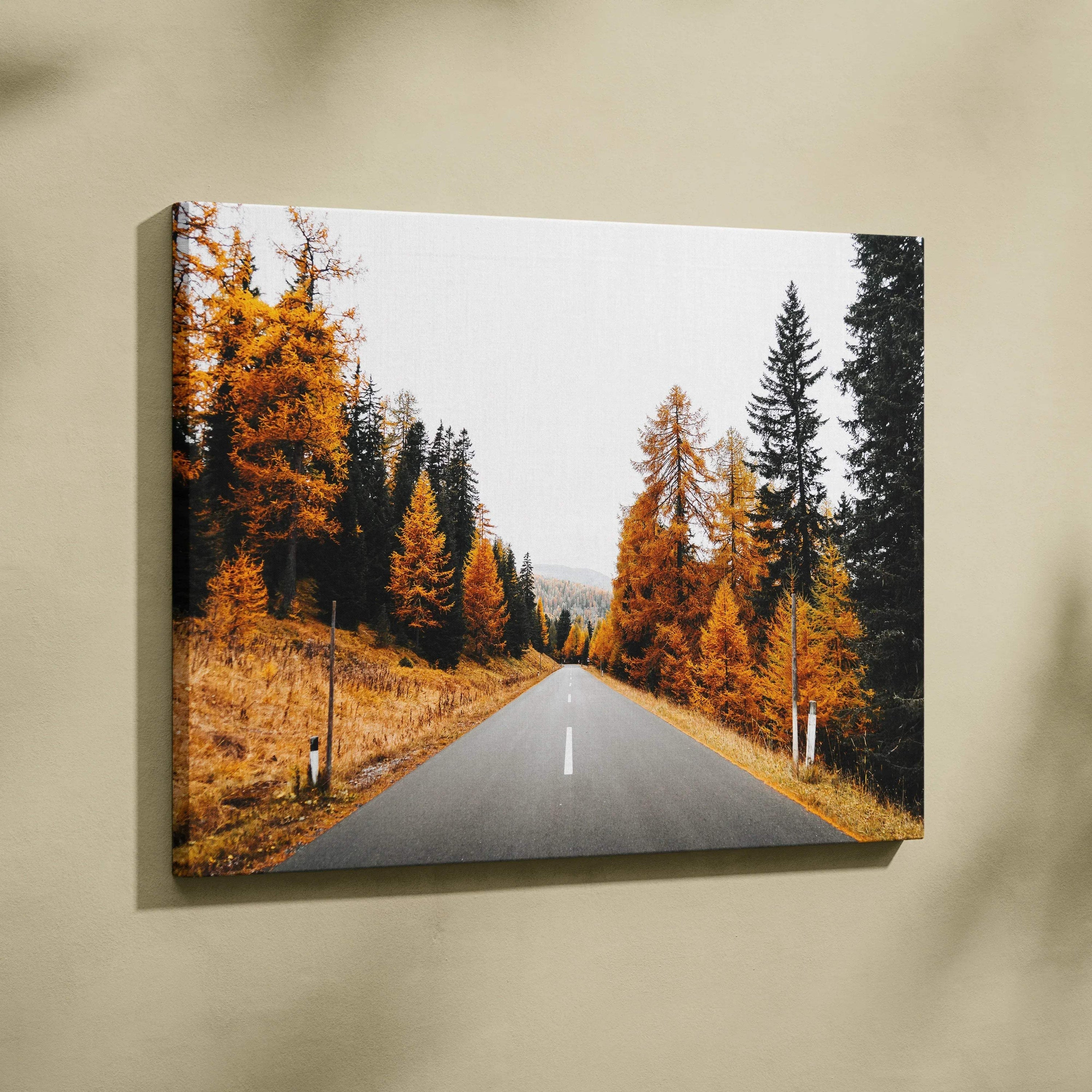 Autumn road lined with orange and green trees on vibrant nature canvas wall art.