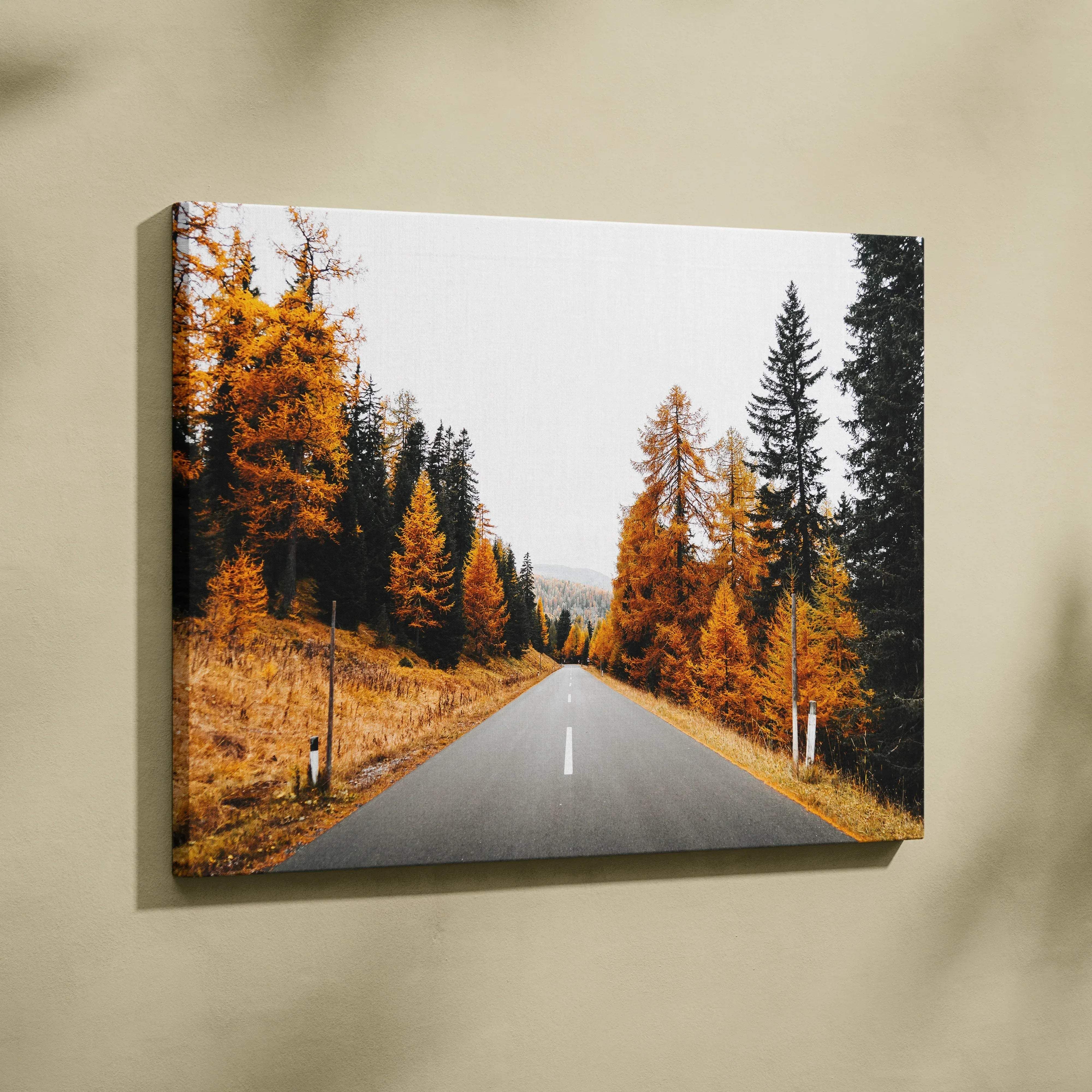 Canvas wall art of autumn landscape featuring a winding road with golden and dark green foliage for warm decor