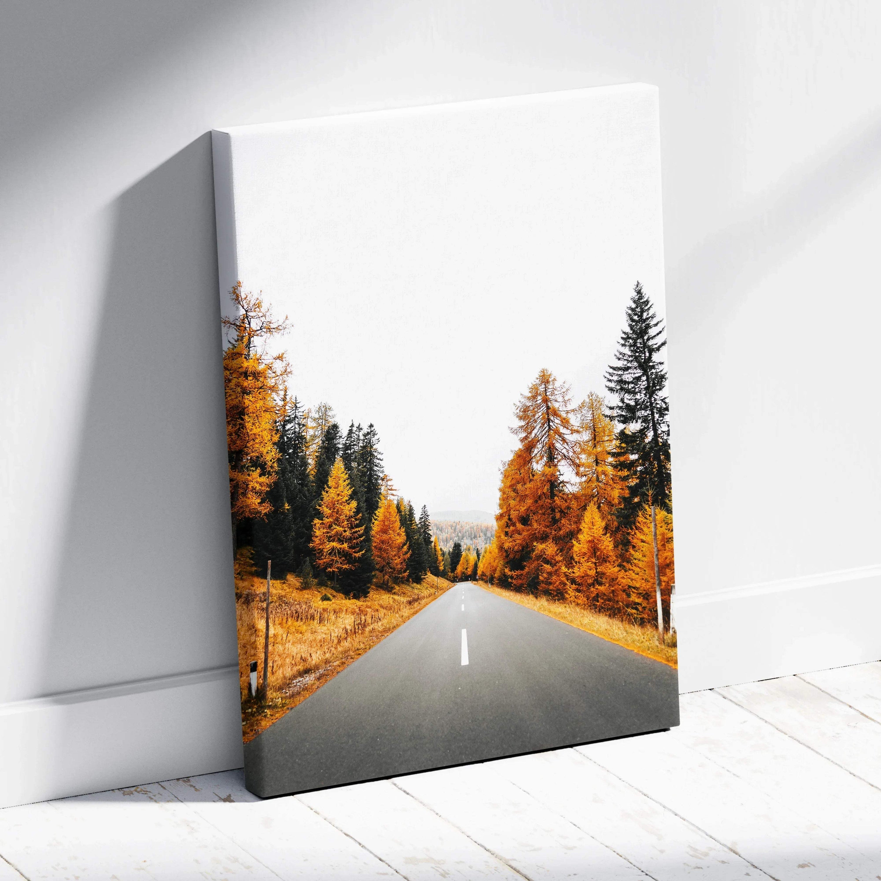 Vertical canvas wall art featuring a vibrant autumn road flanked by orange and green trees.