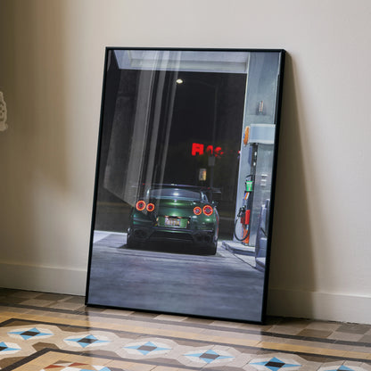 Nissan GTR R35 at gas station night poster wall art with sleek black frame on patterned floor.
