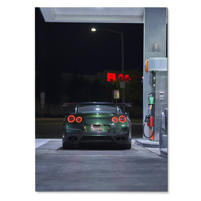 Nissan GTR R35 rear view at night gas station poster wall art in dark green color.