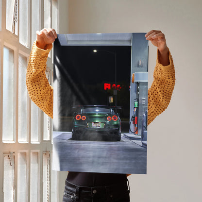 Nissan GTR R35 dark green car at gas station nighttime poster wall art.