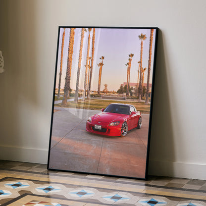 Red Honda S2000 parked on concrete with palm trees in background poster wall art.