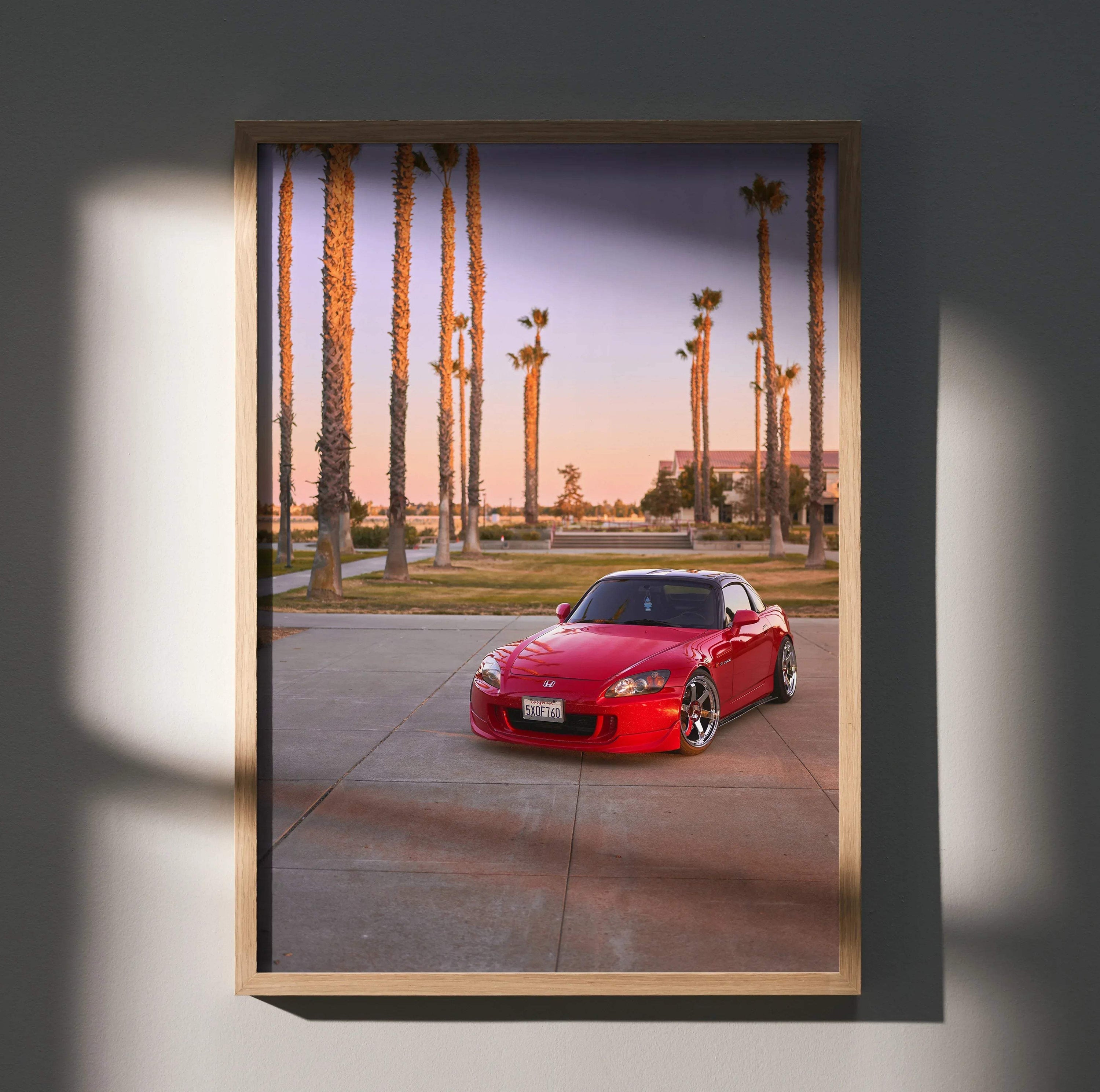 Honda S2000 red sports car parked among palm trees at sunset poster wall art.
