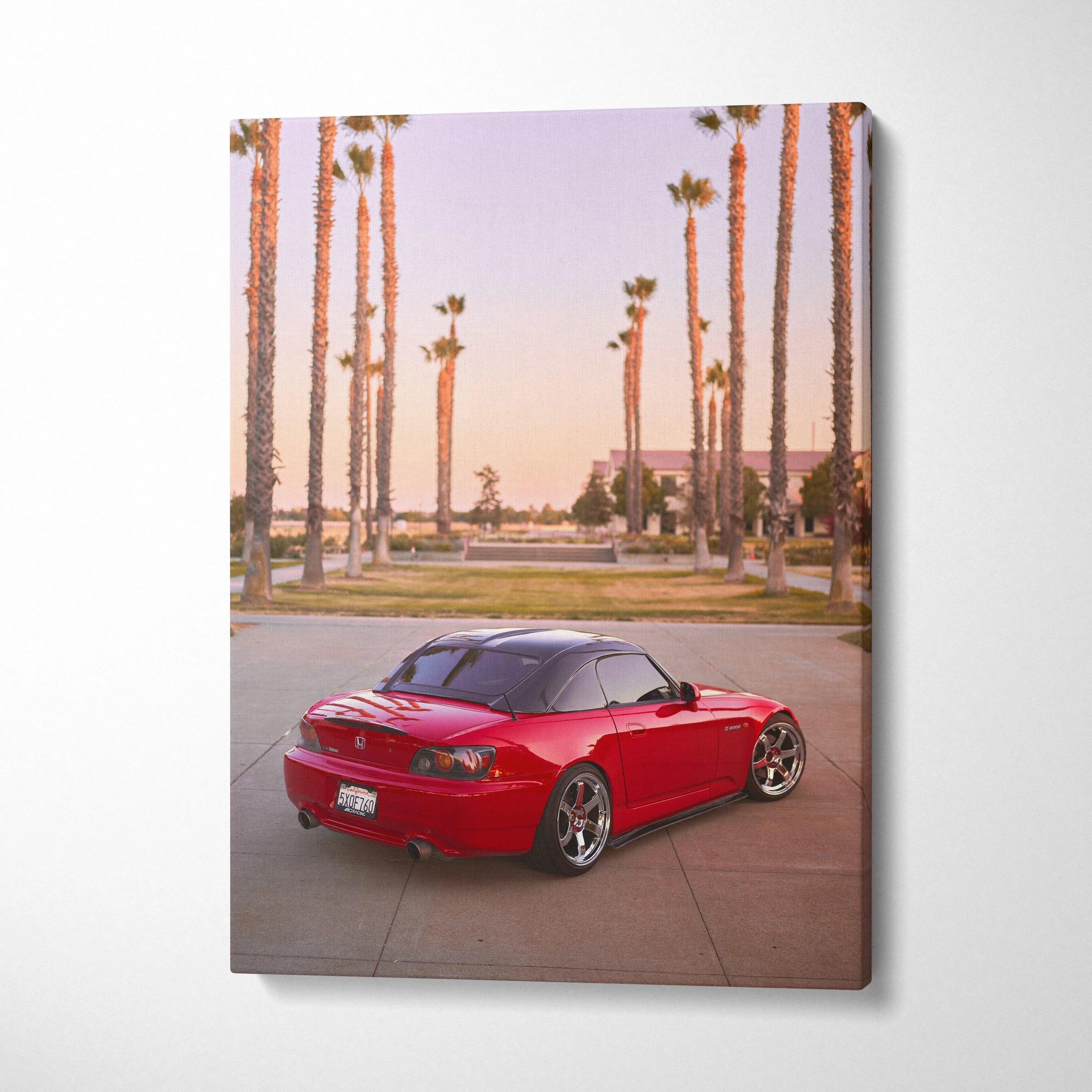 Red Honda S2000 parked with palm trees at sunset on vertical canvas wall art.
