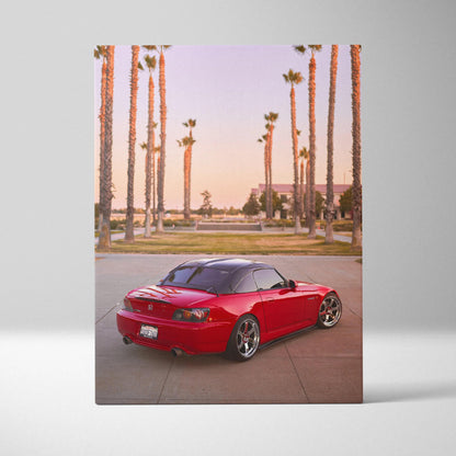 Red Honda S2000 convertible with palm trees sunset background on vertical canvas wall art.