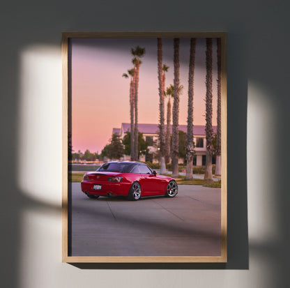 Red Honda S2000 parked on street at sunset with palm trees poster wall art.