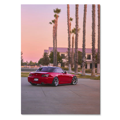 Red Honda S2000 parked by palm trees at sunset, vibrant car poster wall art.