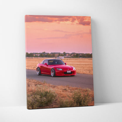 Vertical canvas wall art featuring a red Honda S2000 on a rural road at sunset.