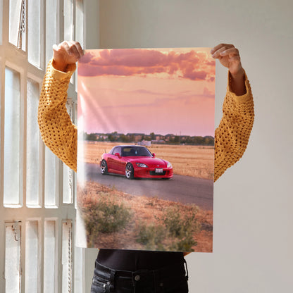 Honda S2000 car driving on road at sunset poster wall art with warm sky colors.