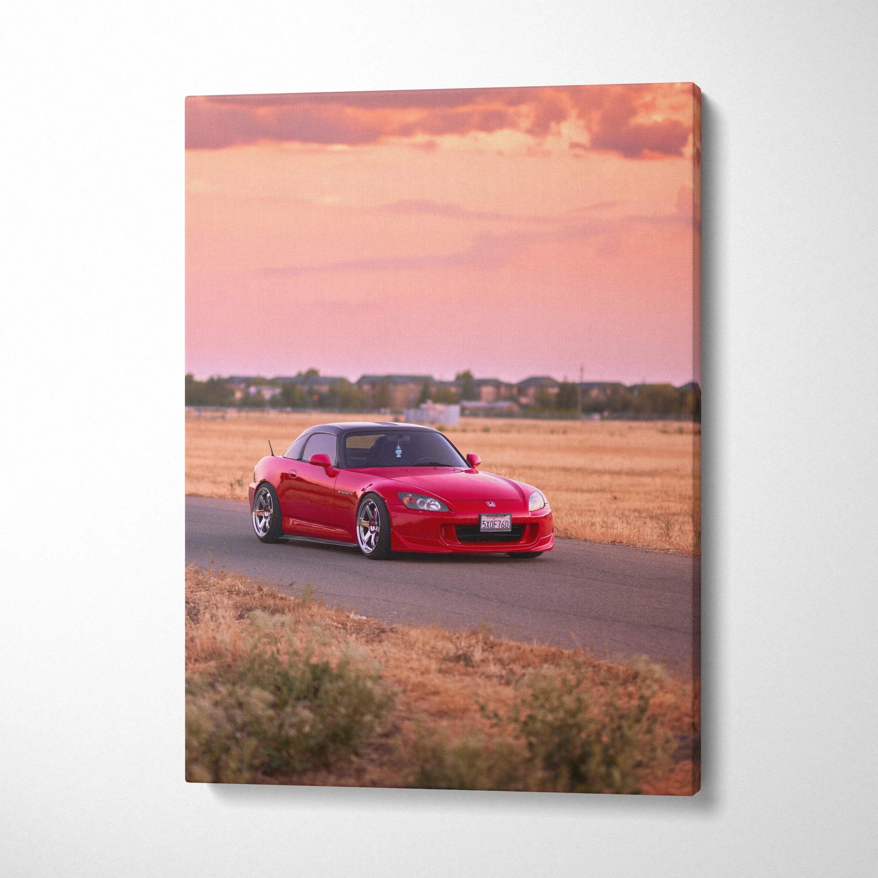 Red Honda S2000 on rural road at sunset printed on vertical canvas wall art.