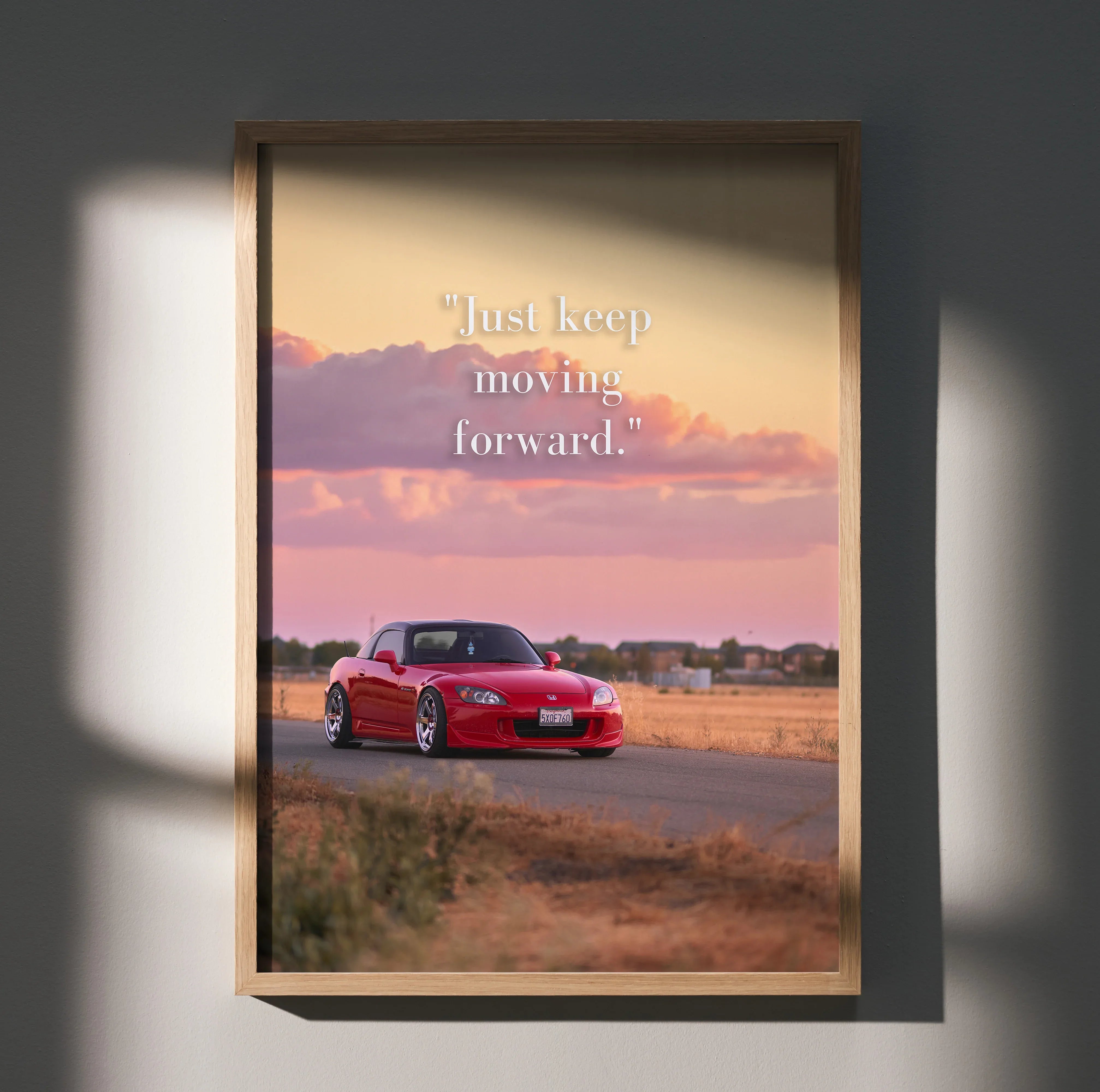 Motivational poster wall art with red Honda S2000 on road at sunset and inspiring text.