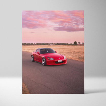 Red Honda S2000 on road at sunset with pink sky vertical canvas wall art.