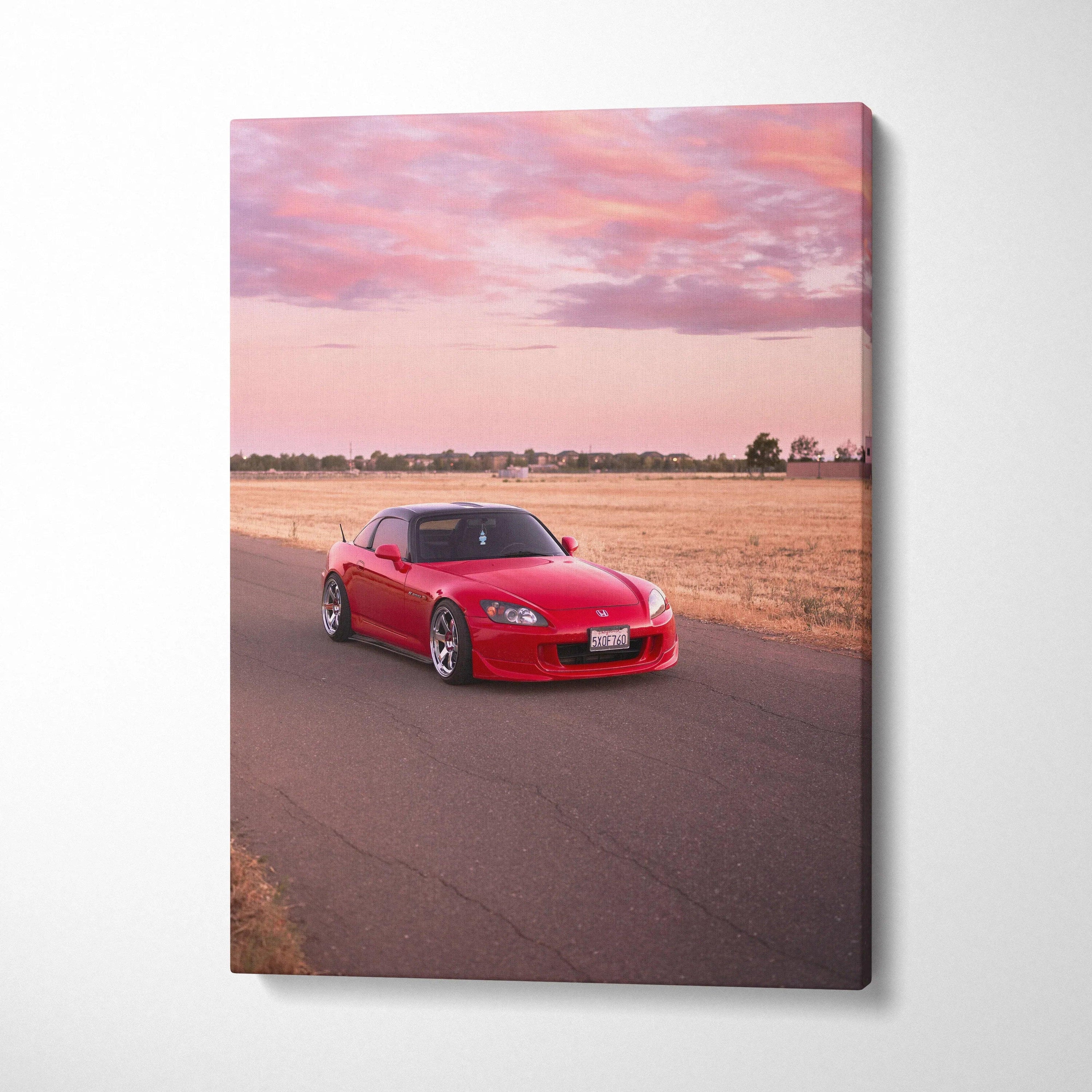 Red Honda S2000 sports car on road at sunset with pink sky, vertical canvas wall art.