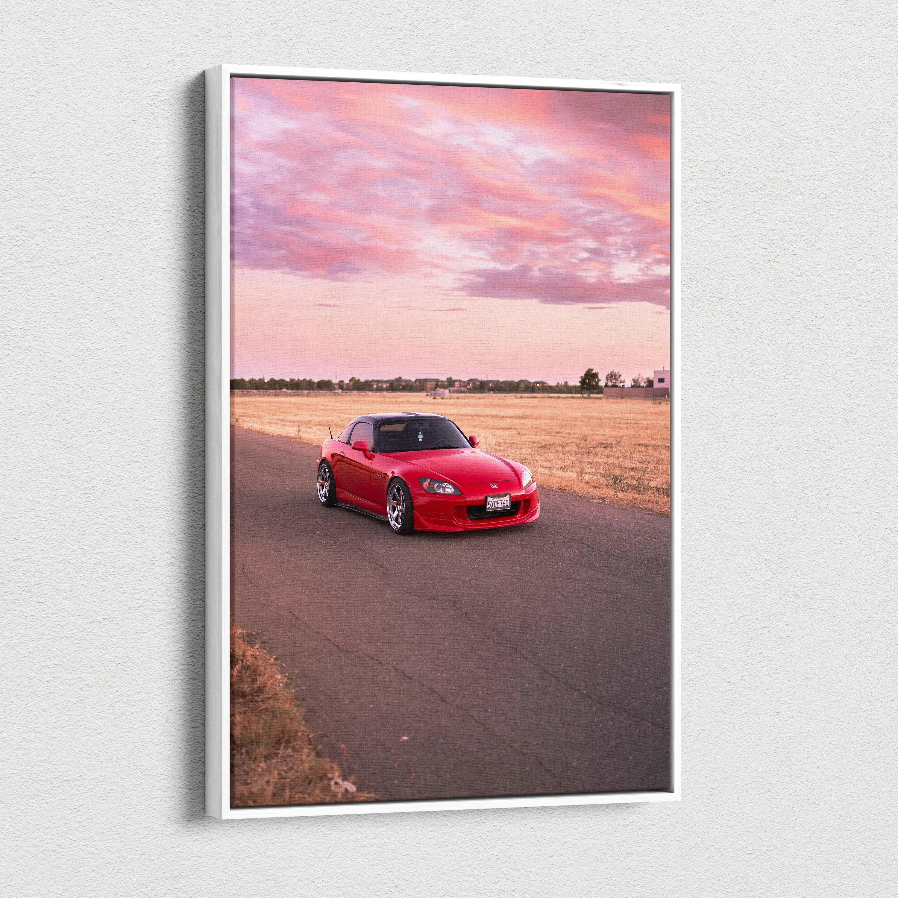 Red Honda S2000 on road at sunset canvas wall art with pink sky and open field backdrop.