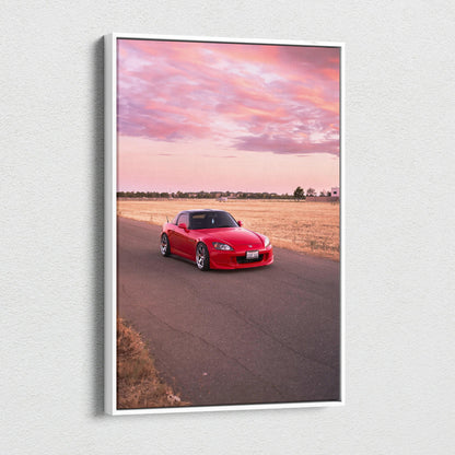 Red Honda S2000 on road at sunset canvas wall art with pink sky and open field backdrop.