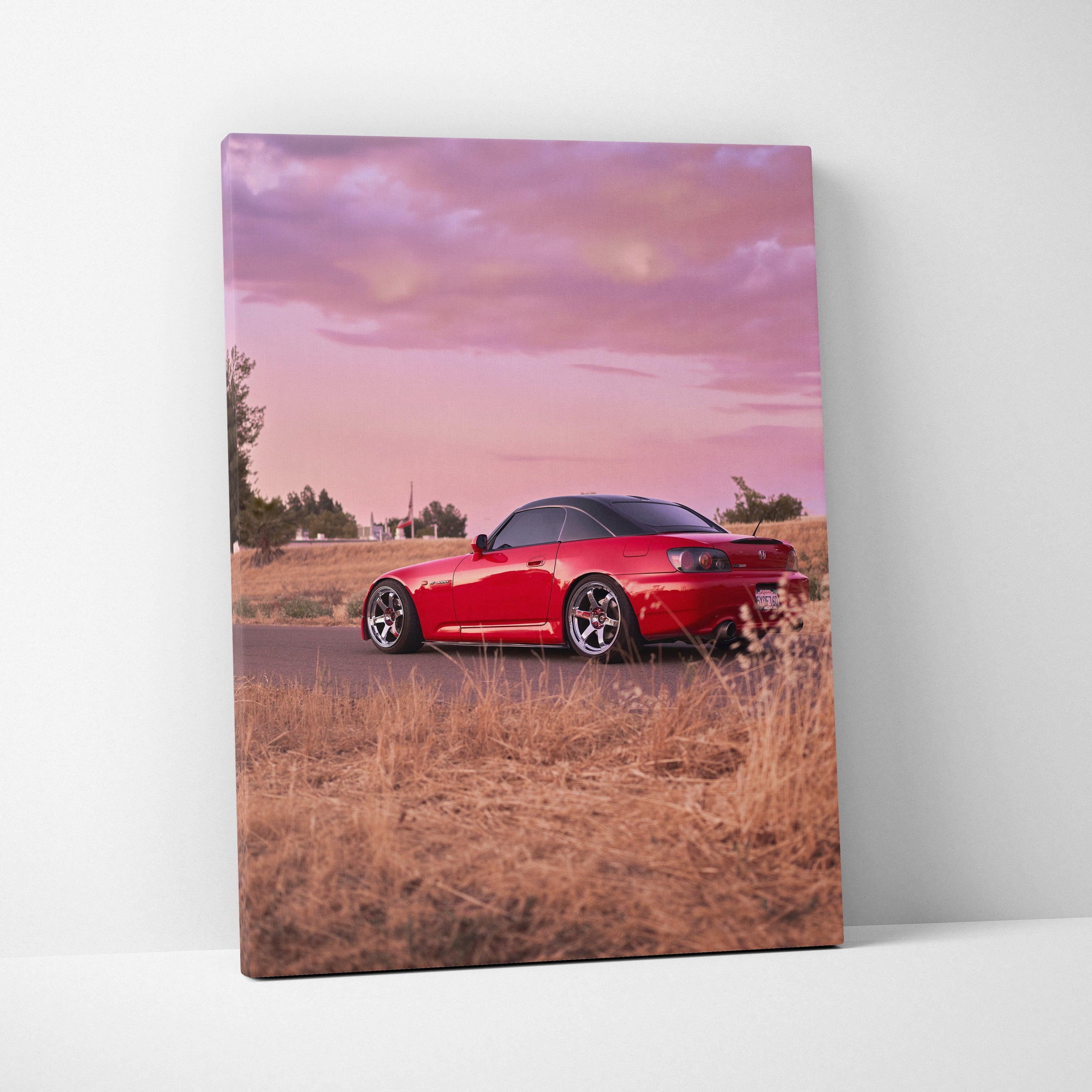 Red Honda S2000 sports car at sunset in dry grass landscape vertical canvas wall art.