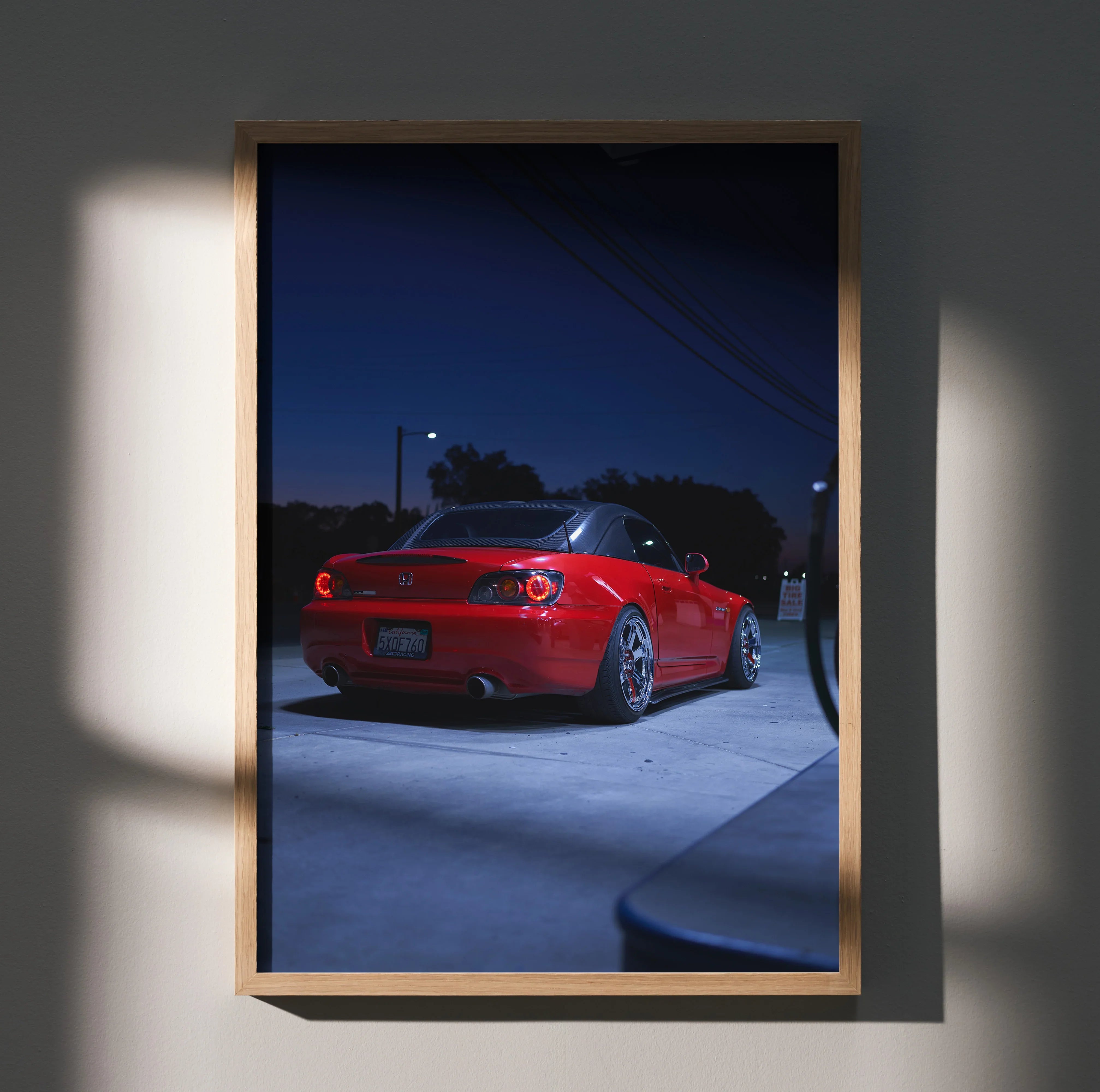 Red Honda S2000 sports car at night in a poster-style wall art with dark blue sky background.