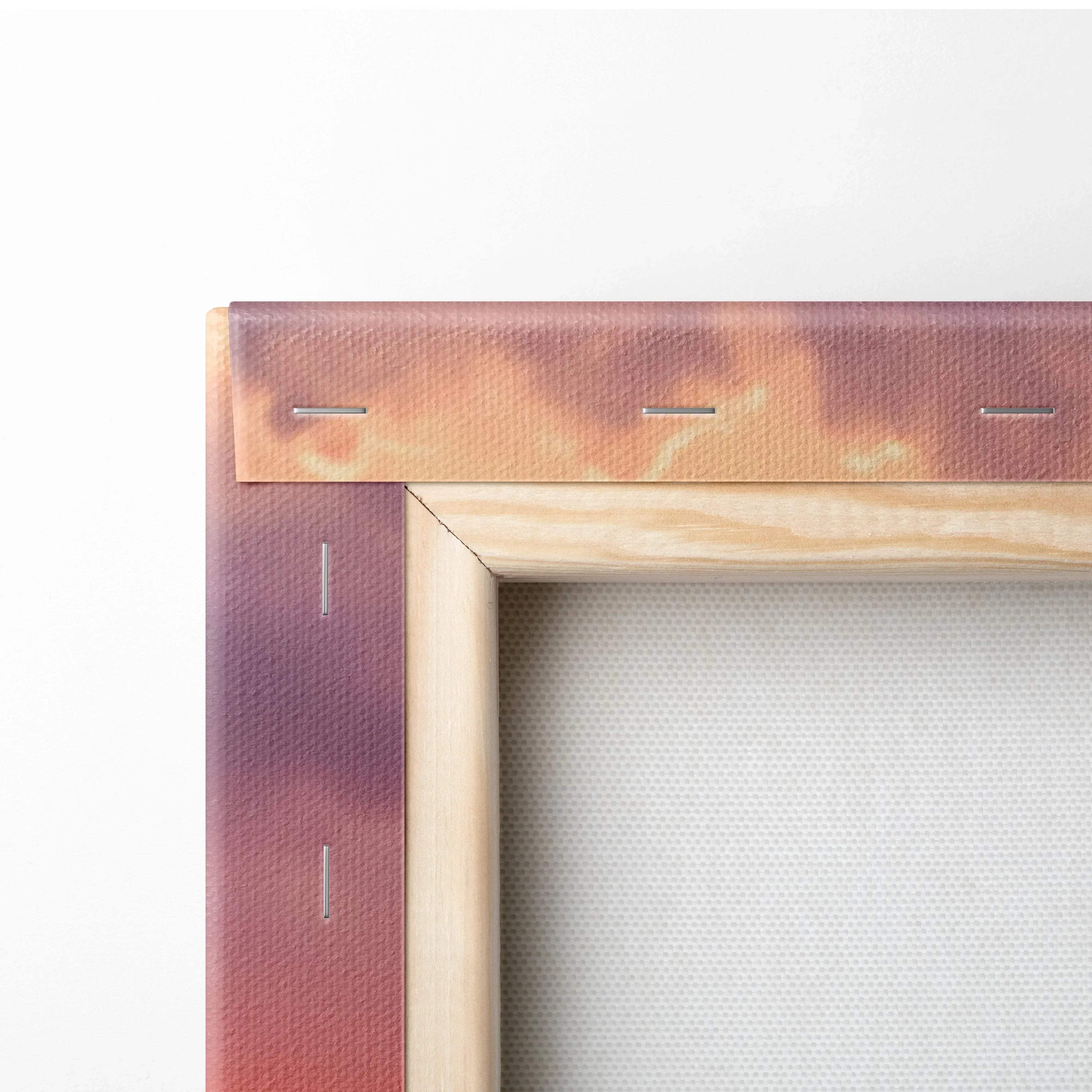 Close-up of wooden stretcher frame corner with vibrant sunset tones on canvas wall art.