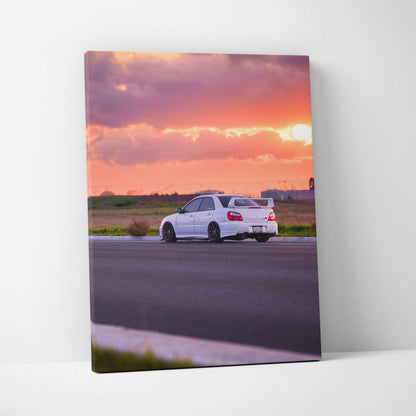 Subaru WRX STI on road at sunset with vibrant sky canvas wall art print.