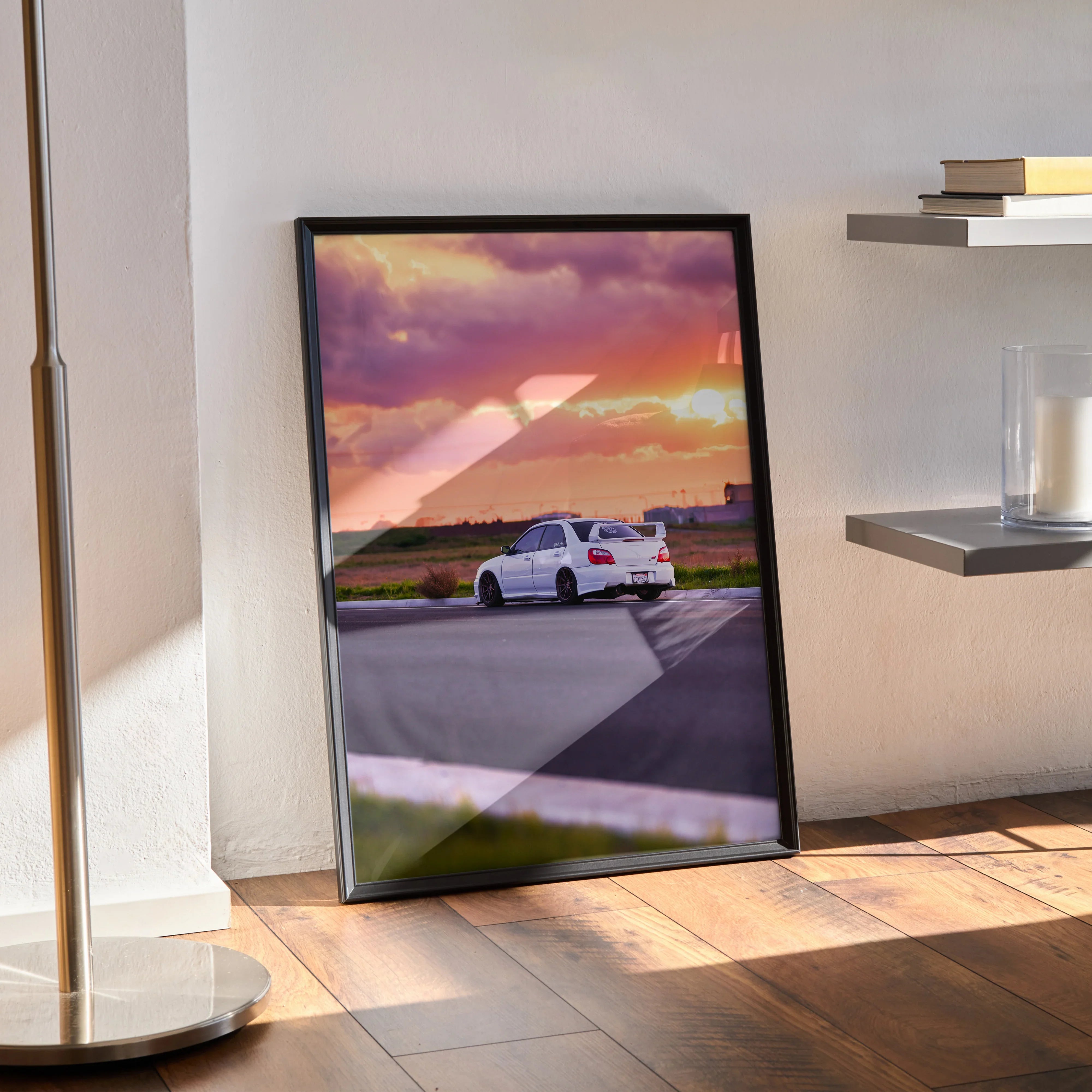 Subaru WRX STI driving on road at sunset poster wall art in sleek black frame.
