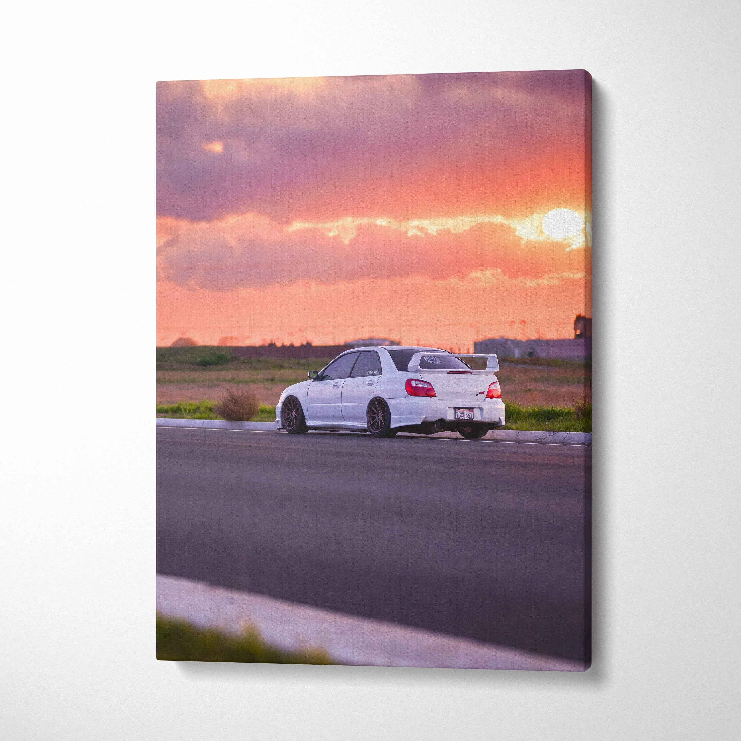 Subaru WRX STI on road at sunset canvas wall art with vibrant sky colors vertical print.