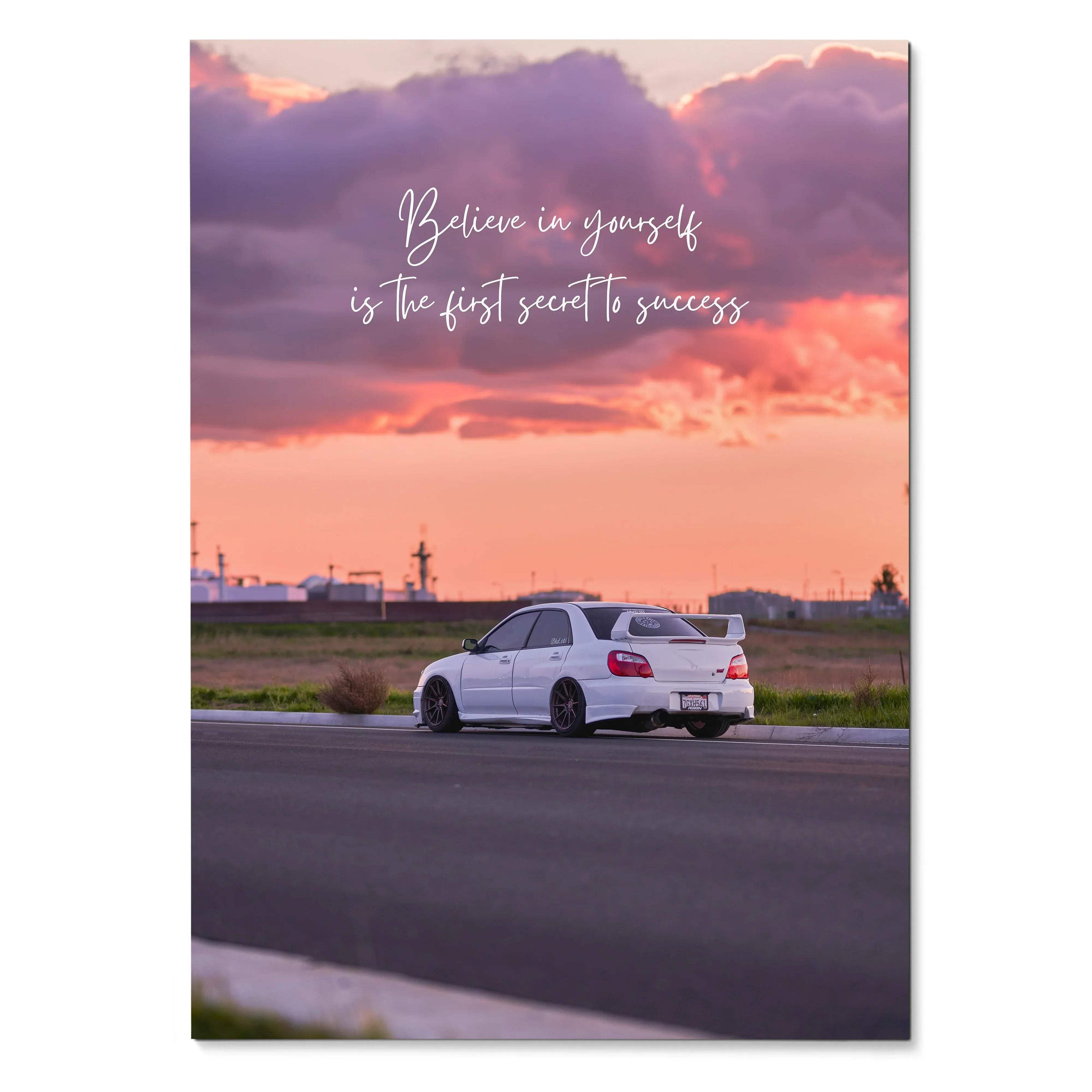 Motivational poster wall art with white Subaru WRX STI under purple and orange sunset sky and "Believe in yourself is the.