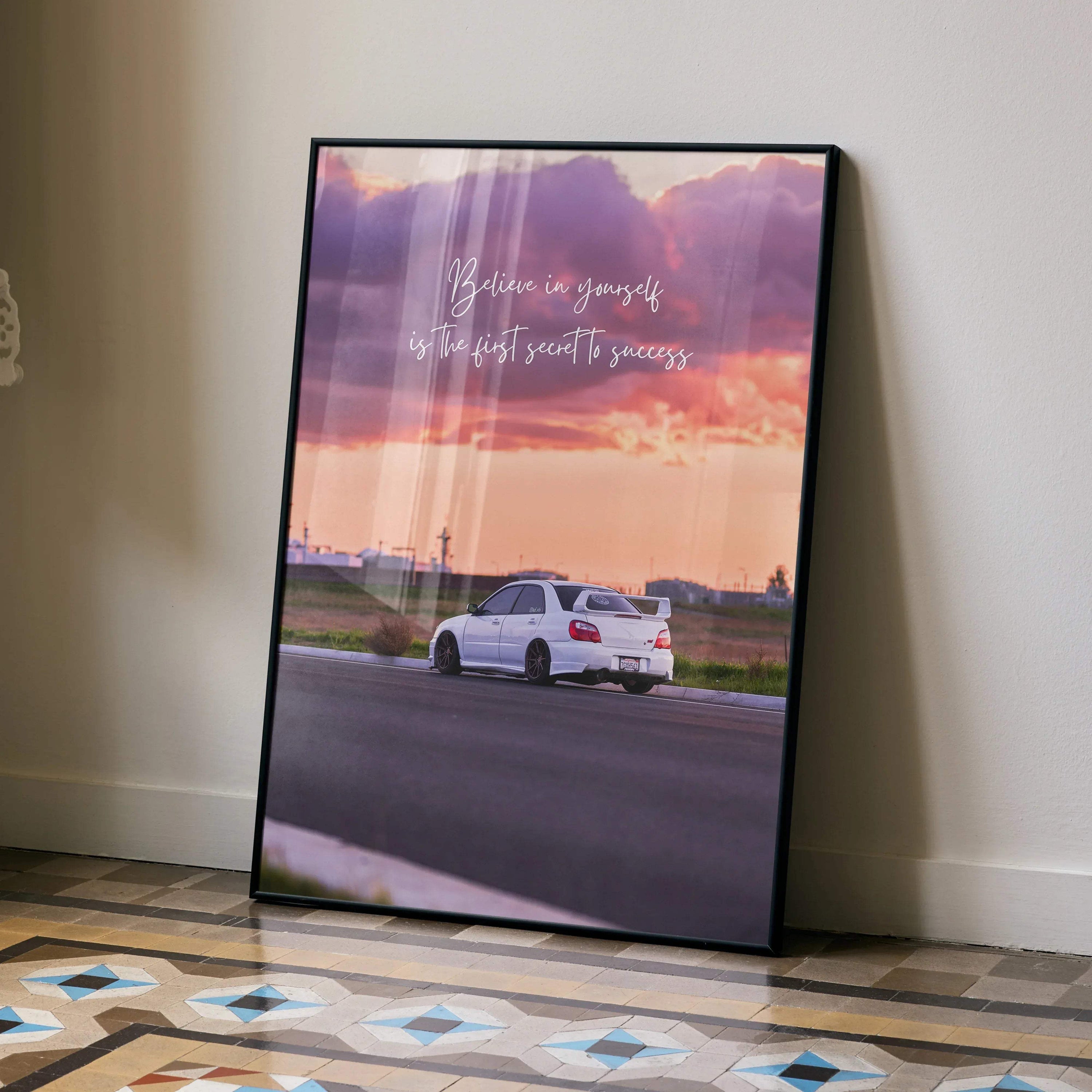 Subaru WRX STI poster with motivational text against a sunset sky, wall art display.