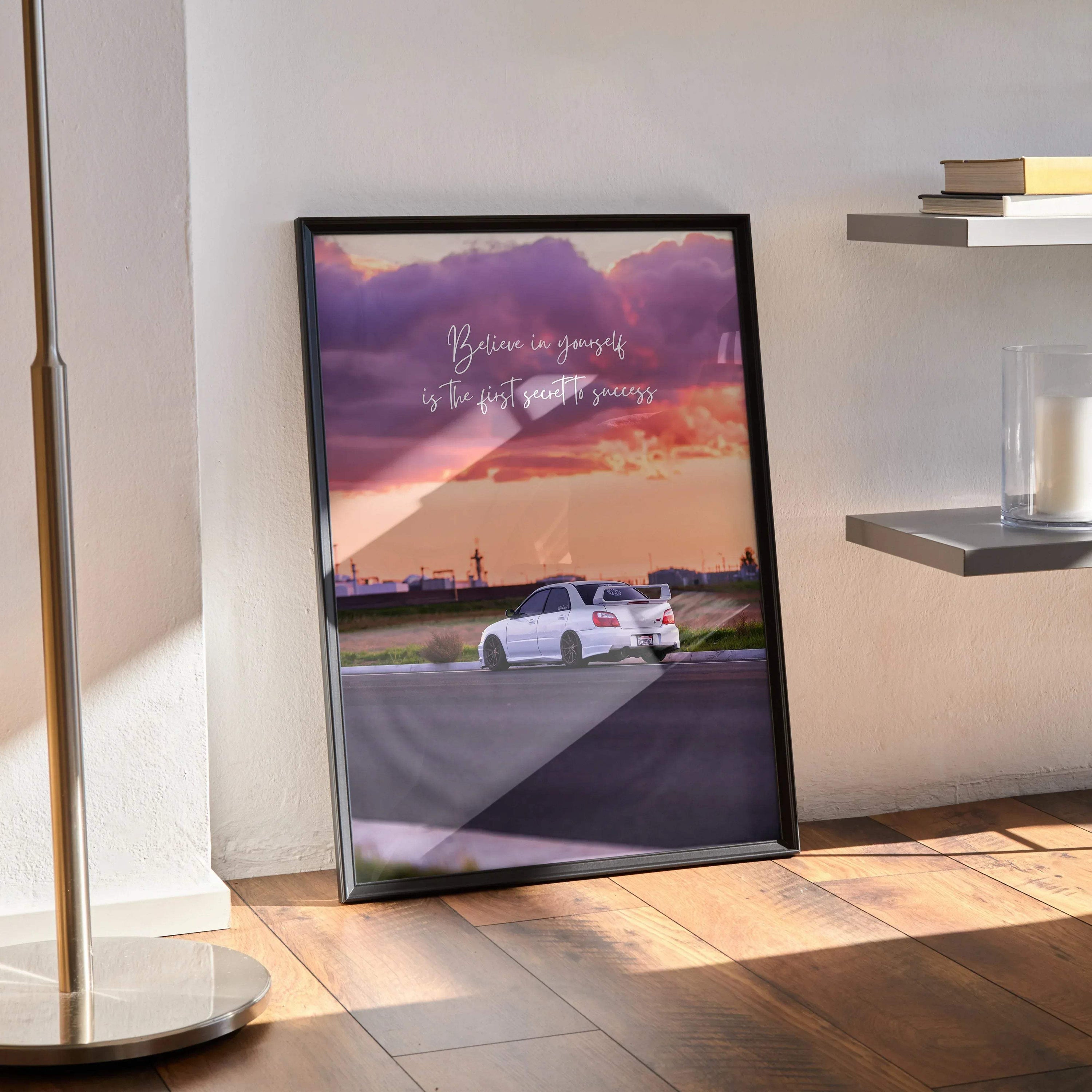Motivational wall art poster featuring white Subaru WRX STI on road with purple and orange sunset sky.