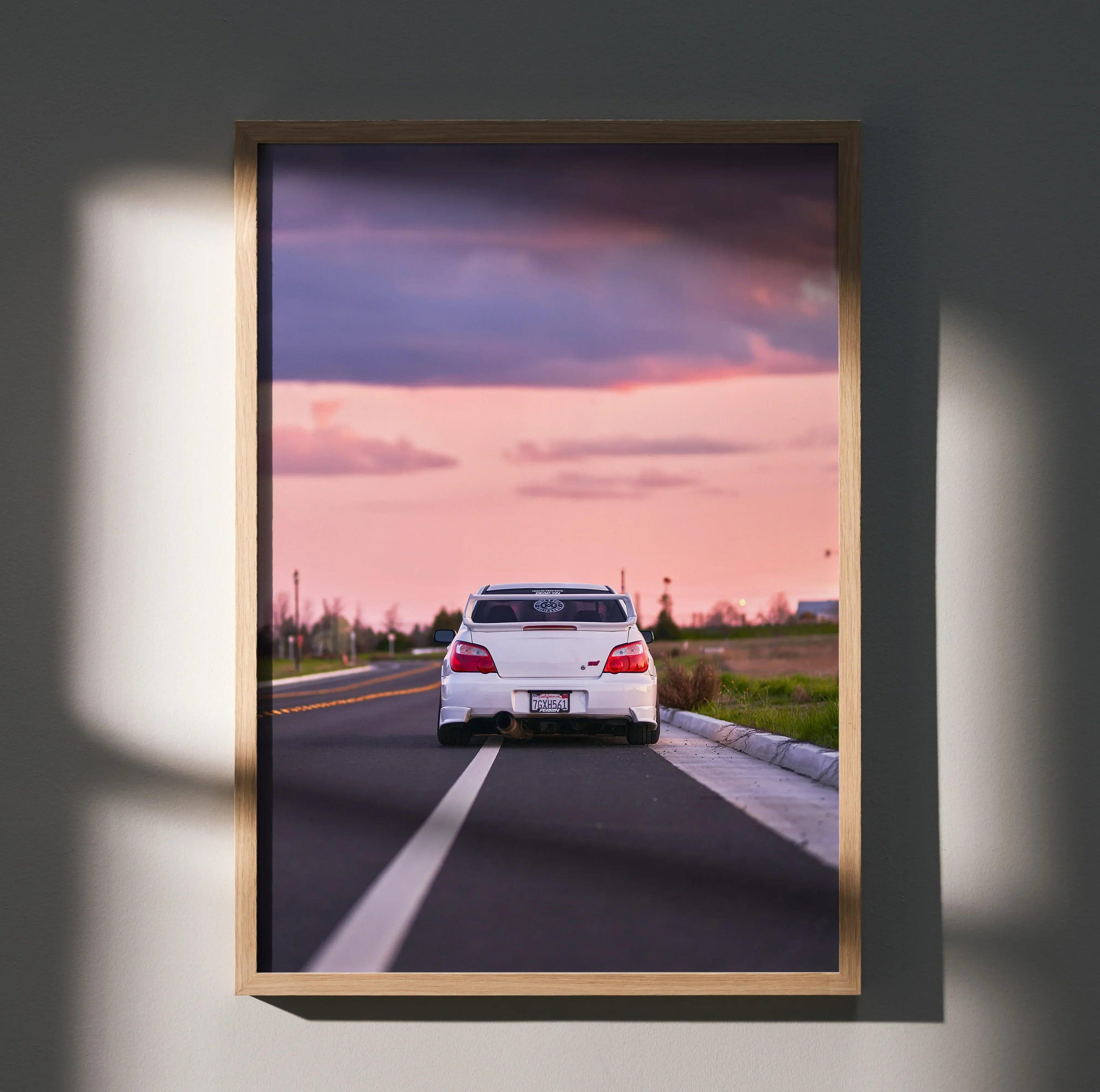 Subaru WRX STI racing car on road at sunset poster wall art with purple and pink sky.