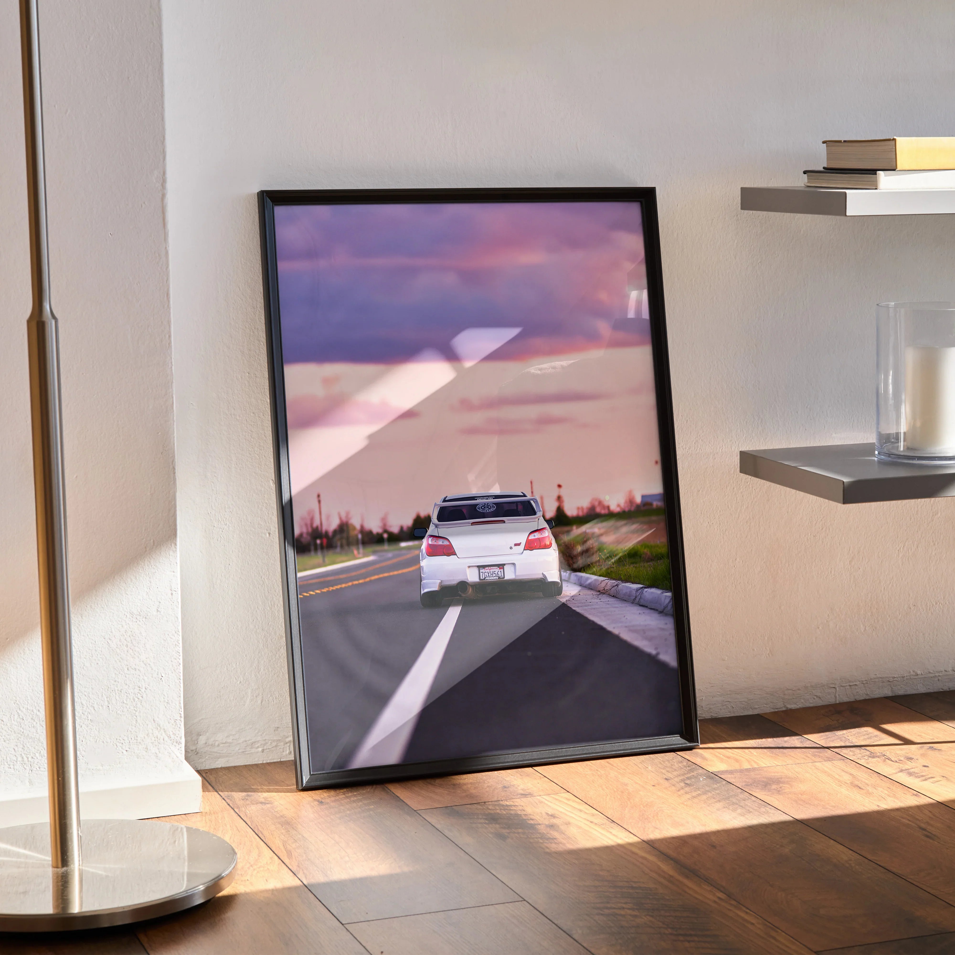 Subaru WRX STI driving at sunset on road poster wall art in black frame.