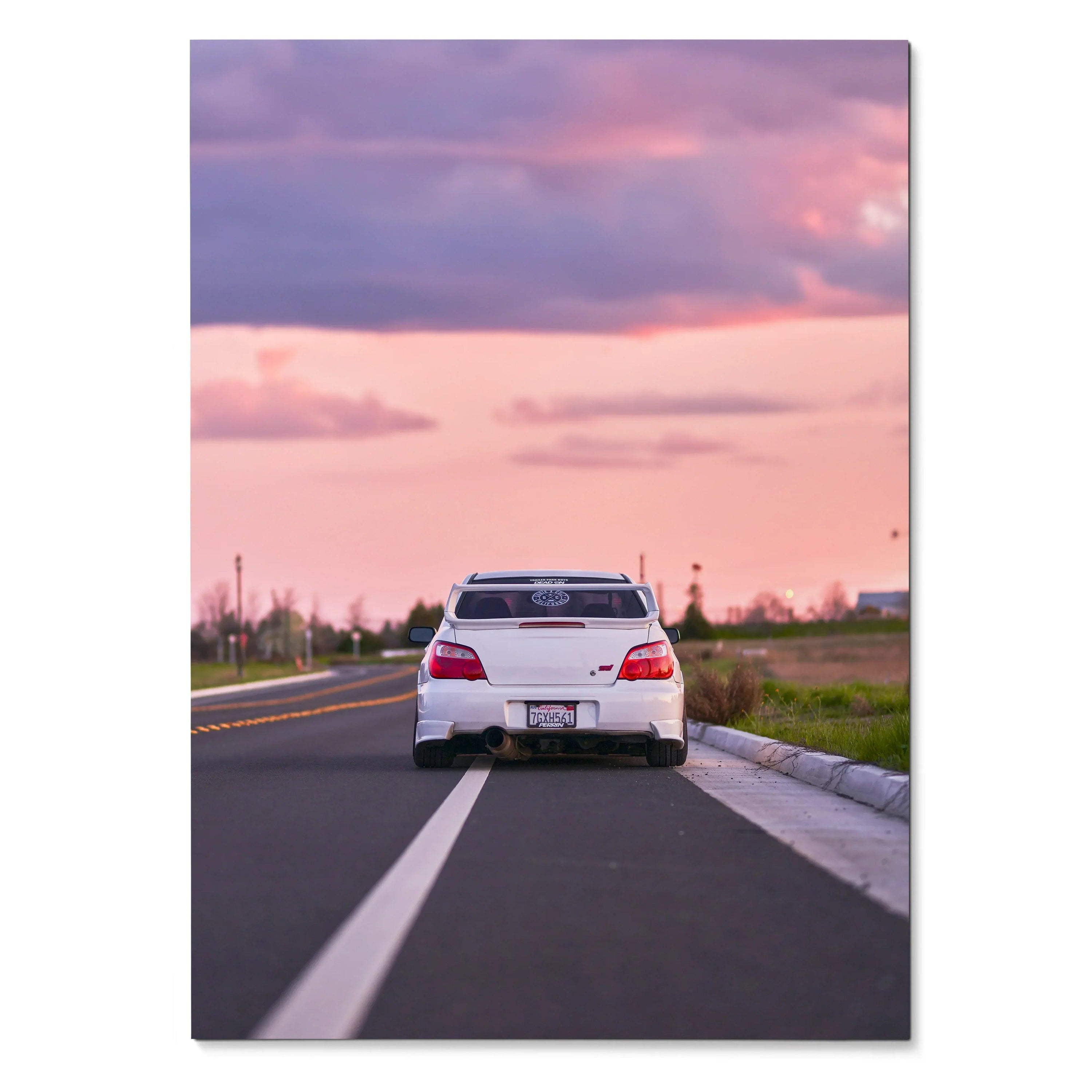 Subaru WRX STI rear view on road at sunset poster wall art with pink sky background.
