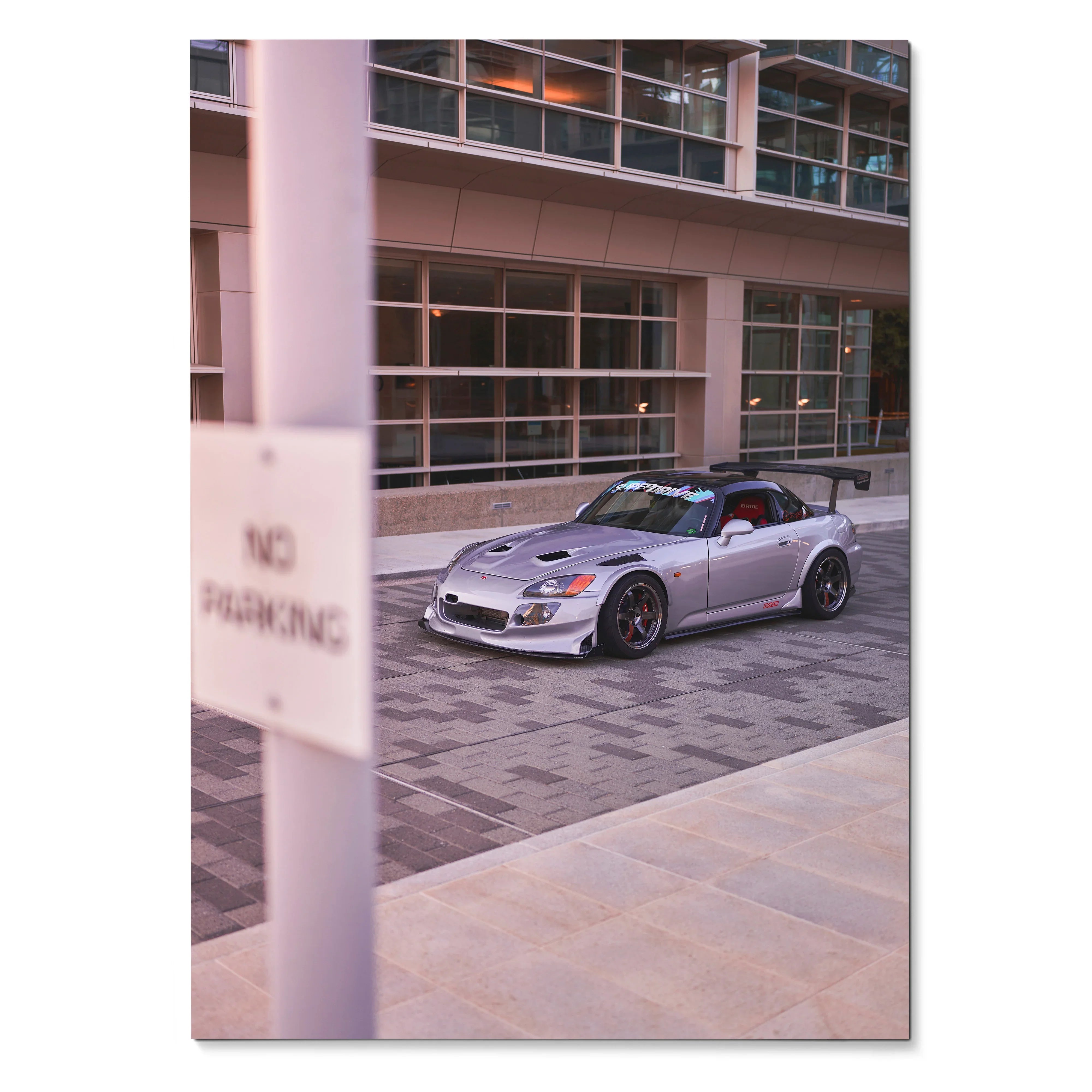 Honda S2000 parked in modern urban setting poster showcasing sleek silver sports car wall art.