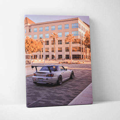 Honda S2000 parked under palm trees in urban setting canvas wall art.