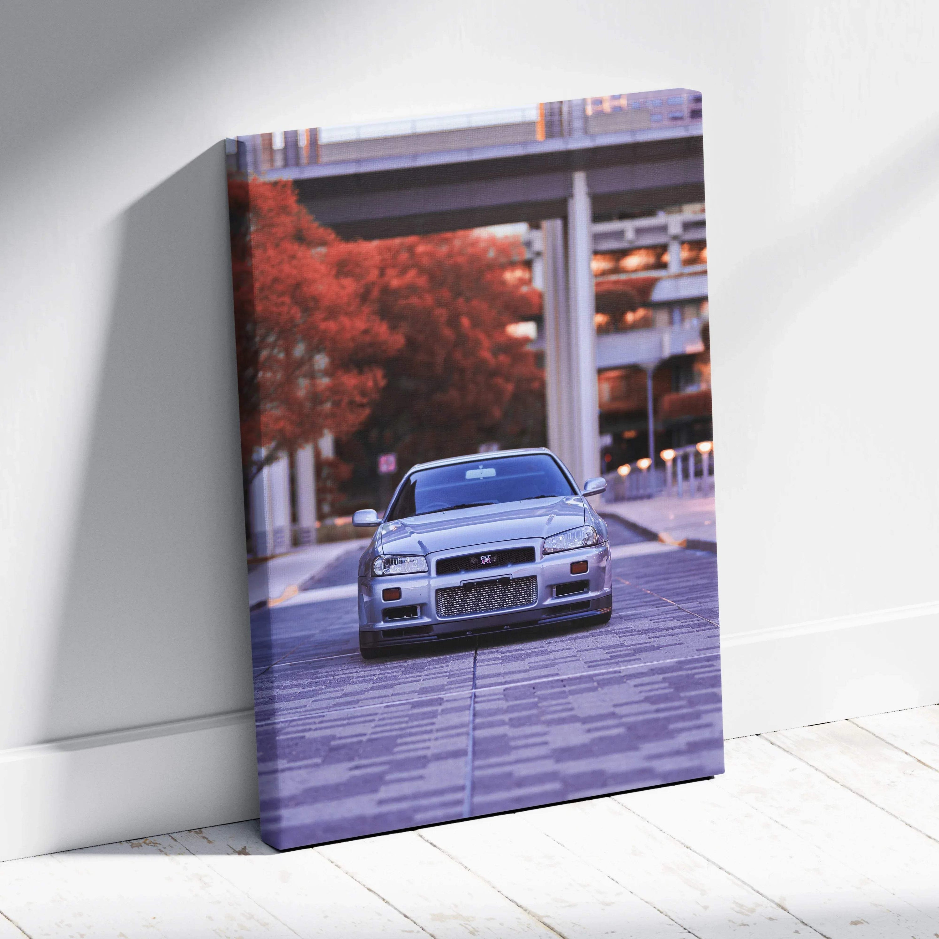 Vertical canvas wall art featuring a silver Nissan GTR R34 Skyline in an urban setting with red autumn trees.
