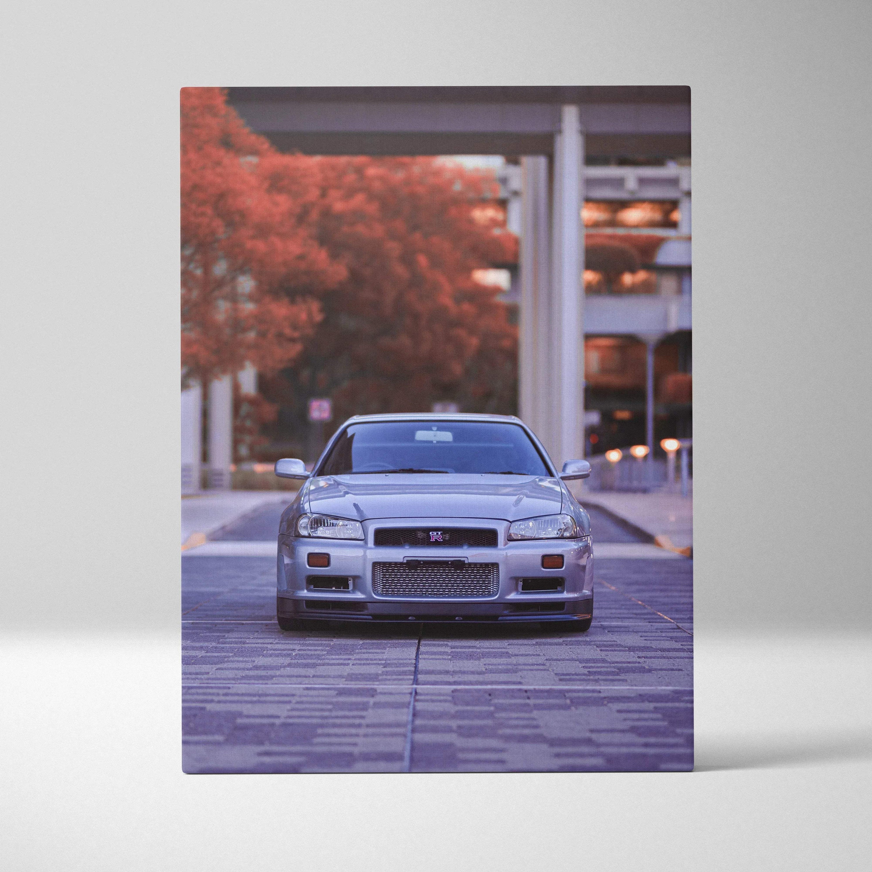 Vertical canvas art featuring a silver Nissan GTR R34 Skyline in an urban setting, wall art for car enthusiasts.