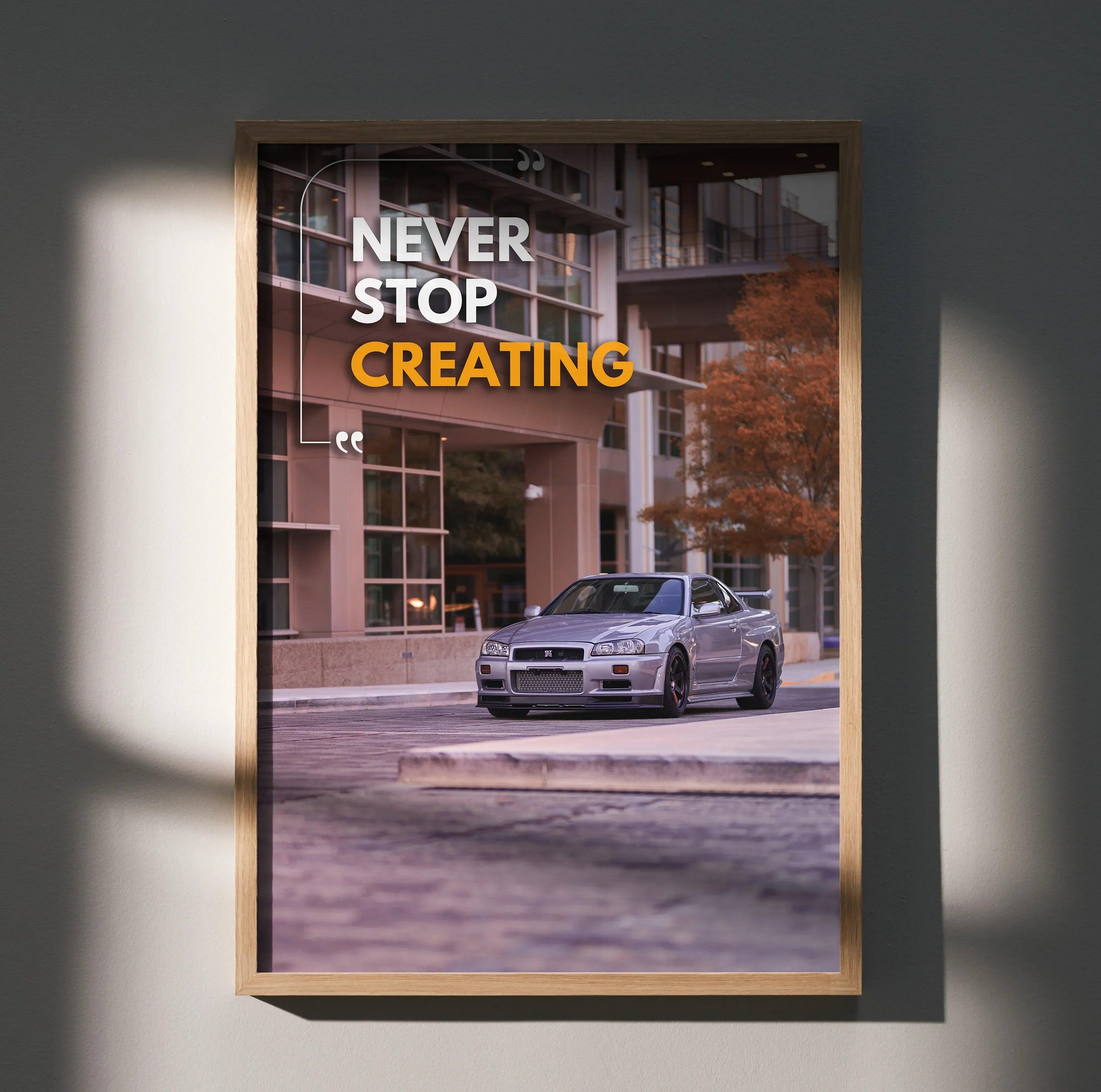 Motivational poster wall art featuring silver Nissan R34 GT-R Skyline with "Never Stop Creating" text in white and yellow.